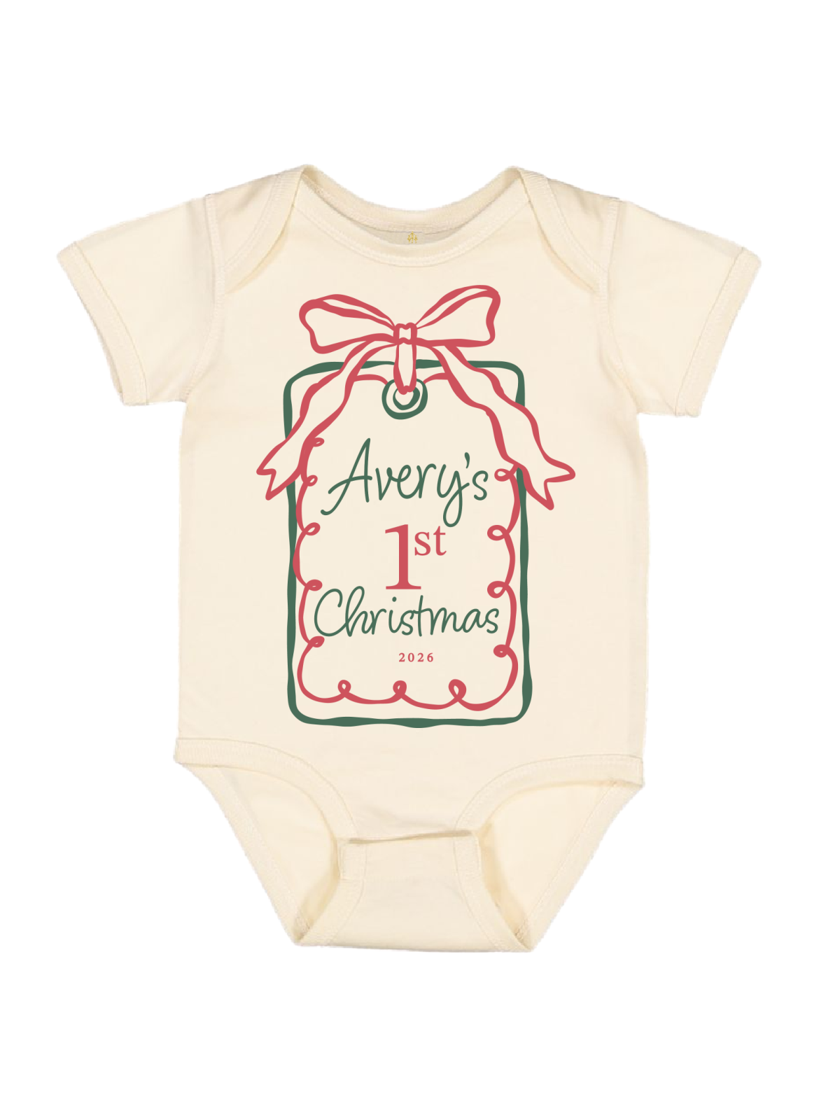An off-white long-sleeve baby bodysuit featuring a Christmas gift tag graphic on the front with a red bow, green border, and the text 'my 1st Christmas 2026'.