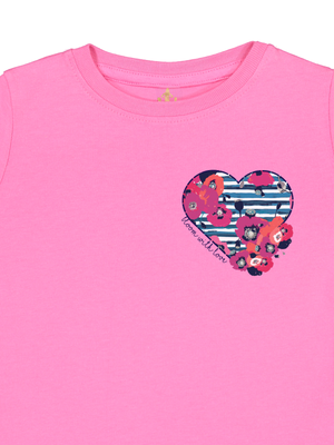 Pink girls t-shirt with floral heart pocket design and navy script that reads "bloom with love," styled as a coordinating Mother's Day outfit.