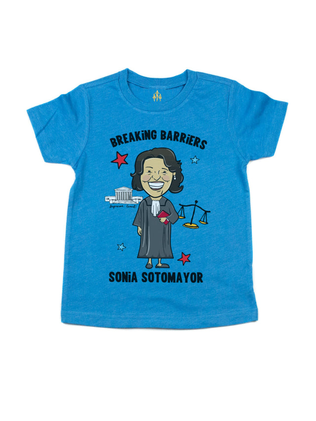 Bright blue kids’ t-shirt honoring Sonia Sotomayor, featuring an empowering "Breaking Barriers" message with stars and a justice scale.