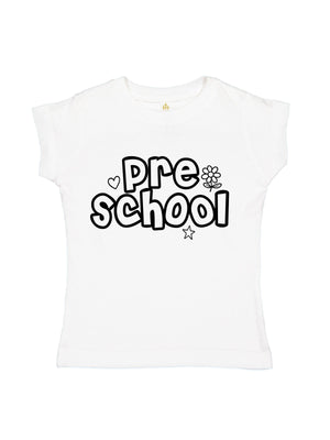 A white short-sleeve baby tee with 'pre school' printed in a black bubbly font on the chest, accompanied by small heart, flower, and star details.