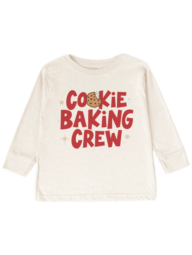 An off-white long-sleeve crewneck shirt with a graphic print that reads 'COOKIE BAKING CREW' in red letters, featuring a chocolate chip cookie illustration and small star accents.