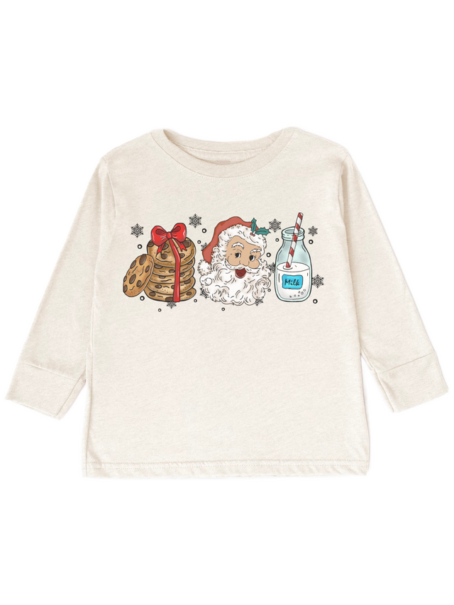 An off-white long-sleeve t-shirt with a Christmas-themed graphic print featuring a stack of pancakes with a red bow, Santa Claus, and a milk bottle on a white background.