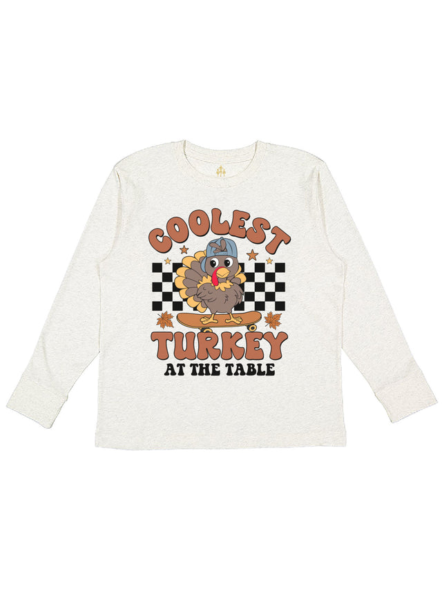 Long sleeve natural kids shirt that reads Coolest turkey at the table