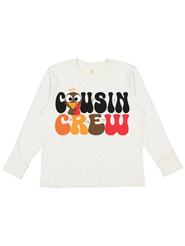 Long sleeve kids Thanksgiving shirt in natural tan that says Cousin Crew with turkey face