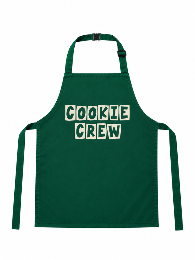 A dark green apron with the words 'COOKIE CREW' printed across the chest in a light beige block-letter style, shown against a plain white background.