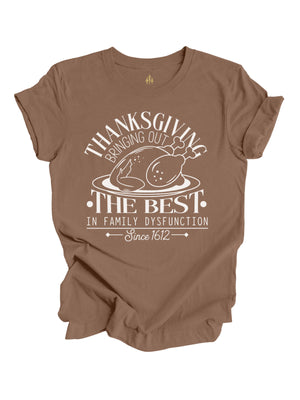 short sleeve brown adult shirt that reads Thanksgiving bringing out the best in family dysfunction since 1612