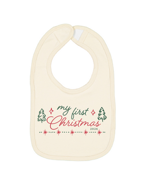 An off-white baby bib with a 'my first Christmas 2026' graphic printed on the front, featuring green and pink text and festive illustrations, set against a plain white background.