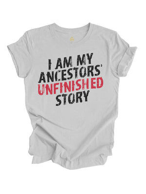 Light gray "I Am My Ancestors' Unfinished Story" t-shirt with bold black and red distressed text, celebrating resilience and legacy.