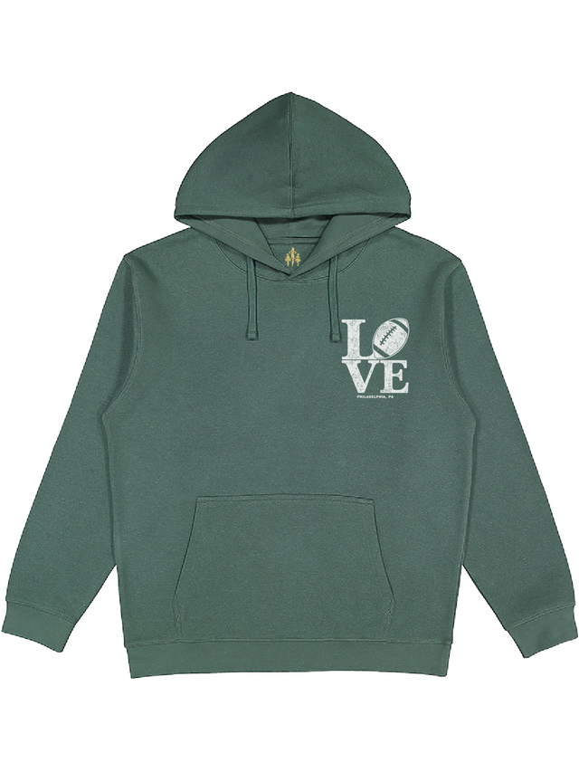 A dark green pullover hoodie with a white graphic on the left chest reading 'LOVE' with a football icon inside the letter 'O'.
