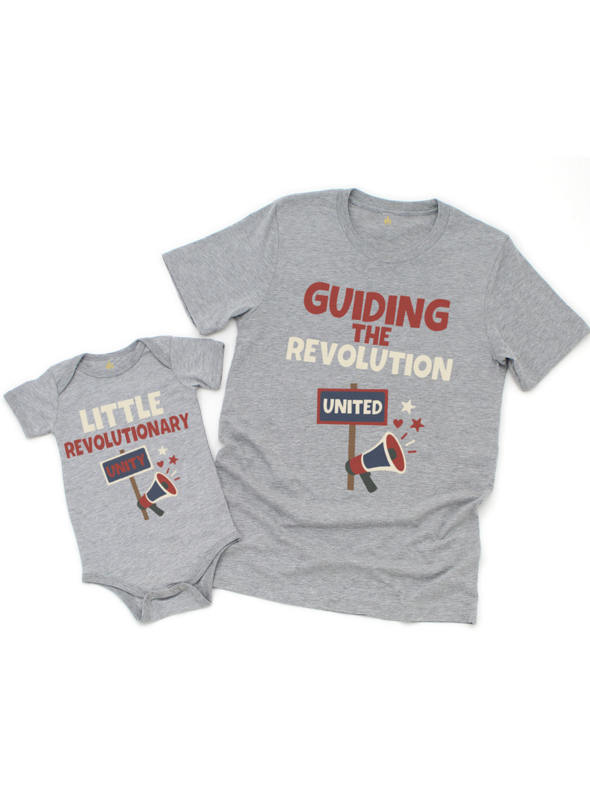 Heather gray infant bodysuit with “Little Revolutionary” text and unity protest sign; matching adult shirt available for family sets