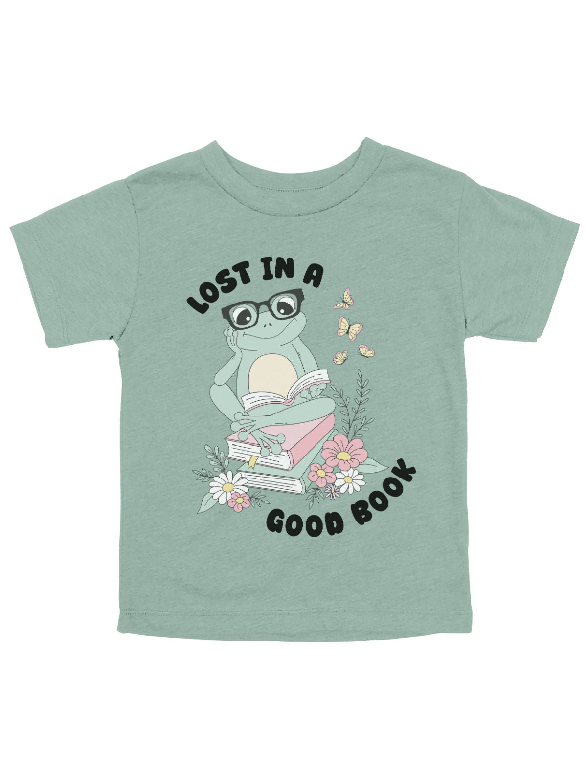 A dusty blue kids spring t-shirt featuring a cute frog with glasses reading on a stack of books, surrounded by flowers and butterflies.