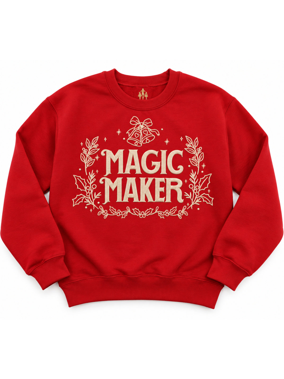A red crewneck sweatshirt featuring a cream-colored graphic on the front with the text 'MAGIC MAKER' surrounded by festive holly leaves and a Christmas bell motif.