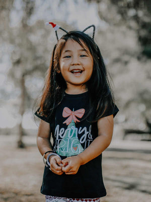 Young girl wearing Merry and Bright Christmas Shirt