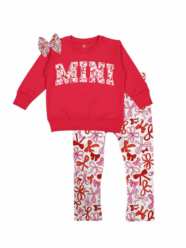 Red "MINI" sweatshirt with a coquette bows design paired with matching white leggings featuring red and pink bows, styled with a coordinating bow hair accessory, displayed flat on a white background.