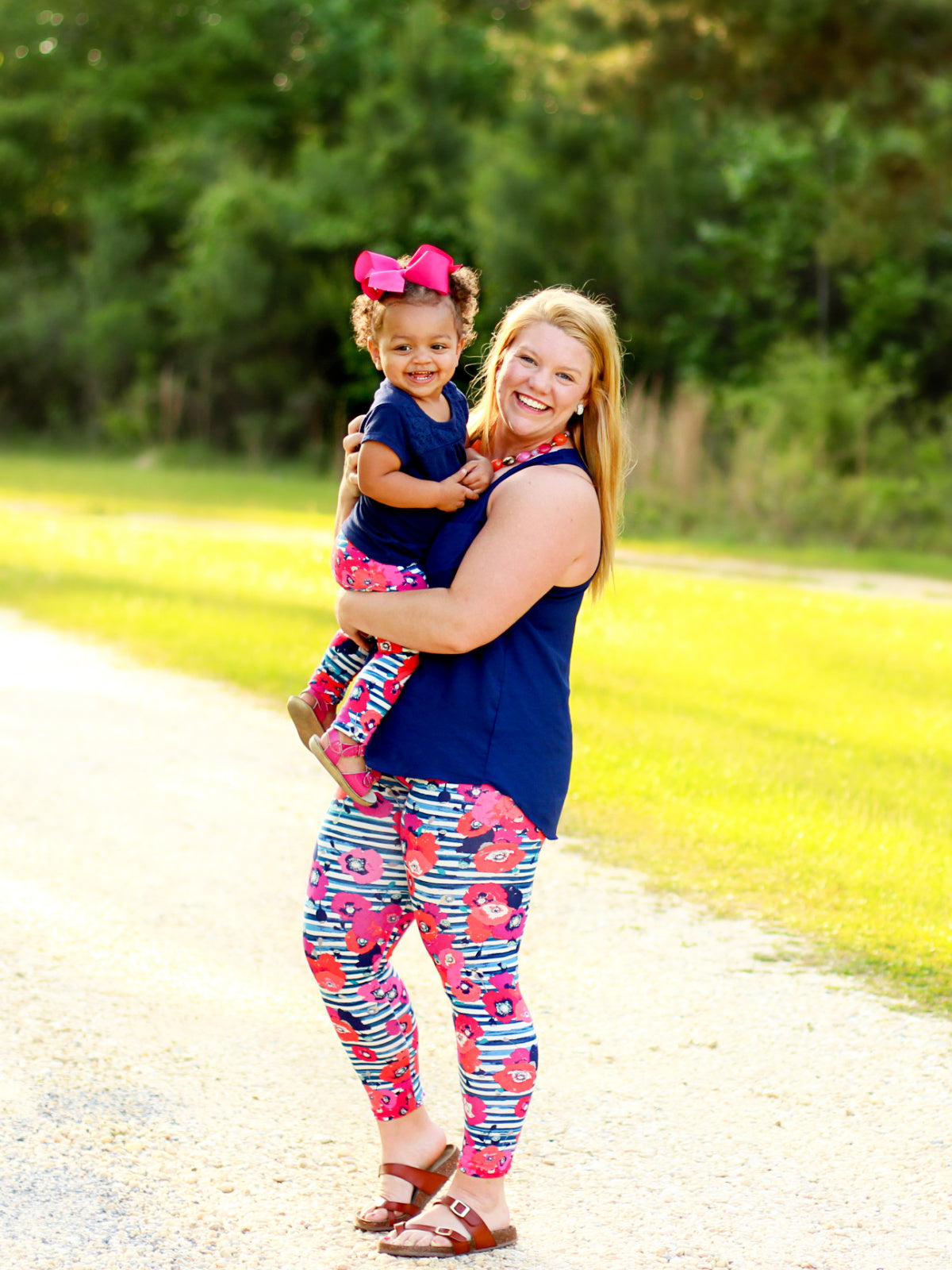Girls floral leggings with red and pink flowers on navy and white striped background, handmade from cotton knit