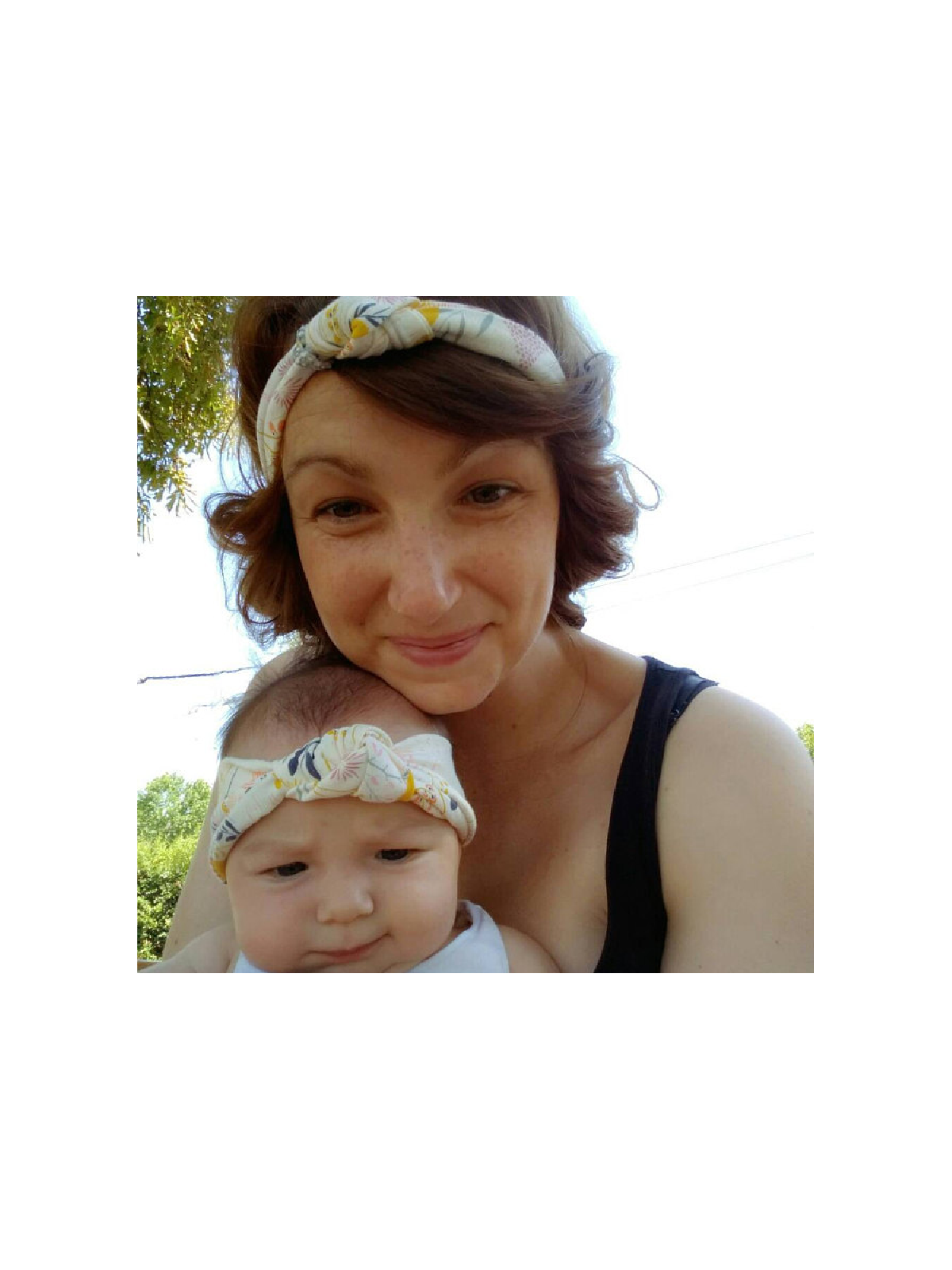 Matching mommy and me knotted headbands with whimsical floral print in pastel and mustard tones