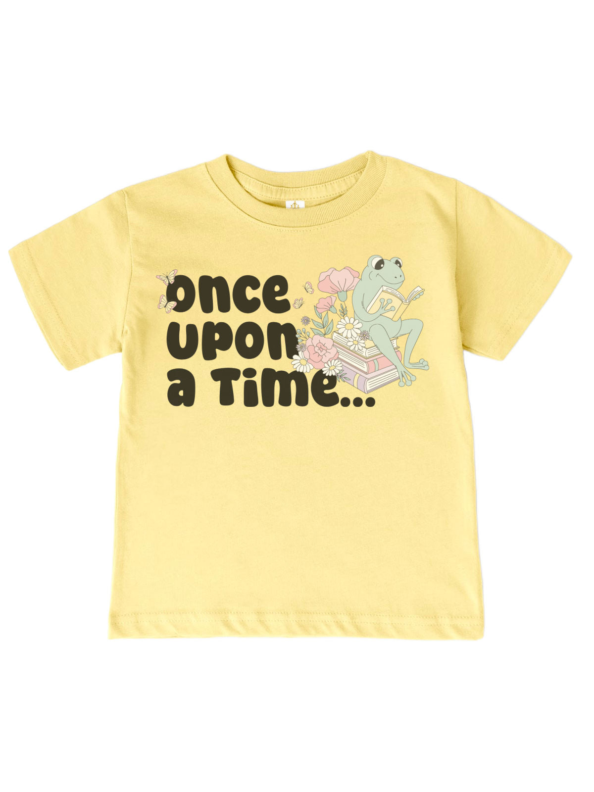 Kids' spring shirt in banana yellow featuring a whimsical frog reading on a stack of books with "Once Upon a Time" text. Soft 100% cotton, unisex fit.