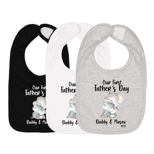 Three baby bibs in black, white, and gray with elephant graphic and text “Our First Father’s Day