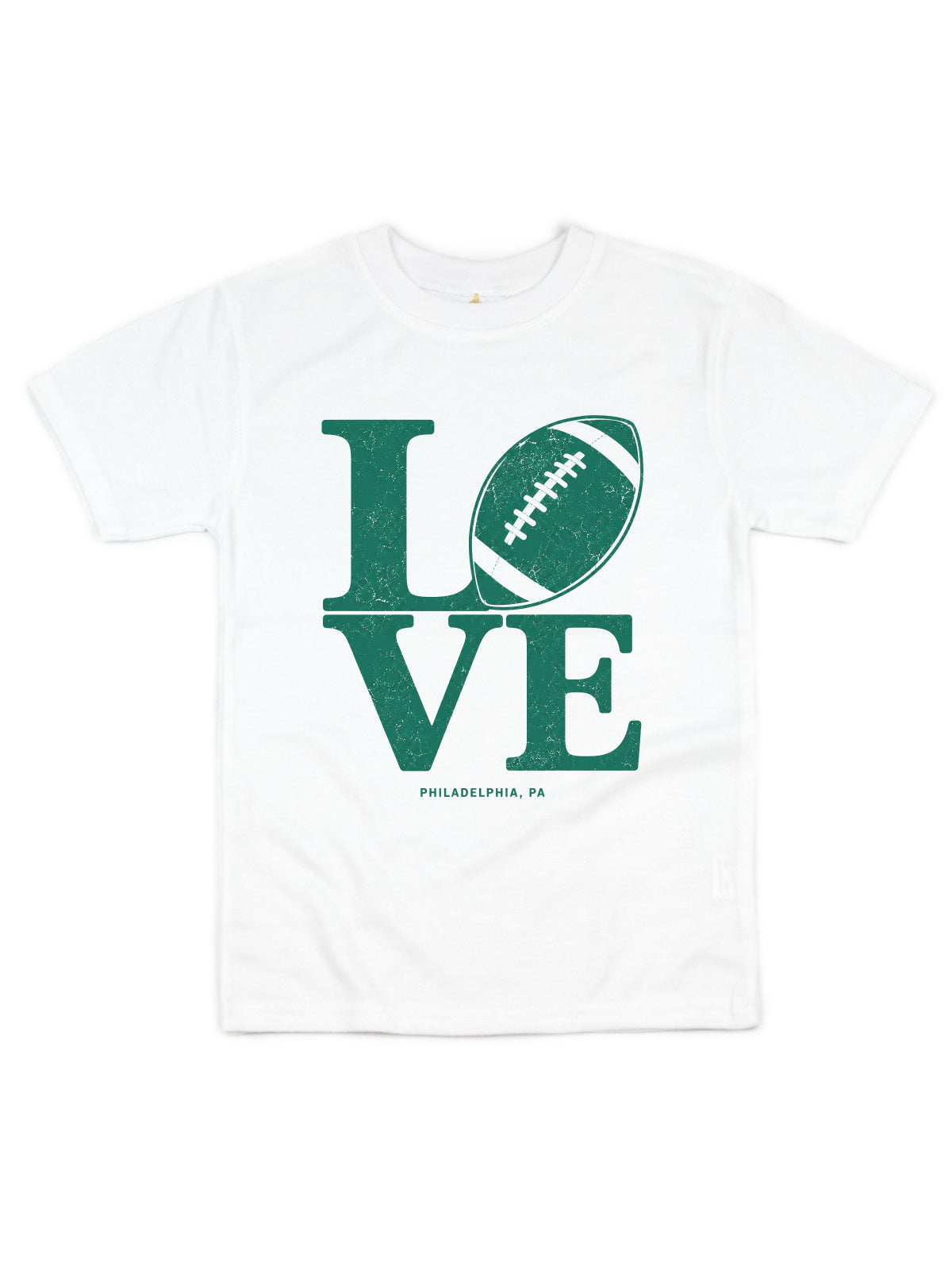 A white short-sleeve crewneck t-shirt featuring a distressed green graphic that spells 'LOVE' with a football representing the letter 'O', and 'PHILADELPHIA, PA' printed below.