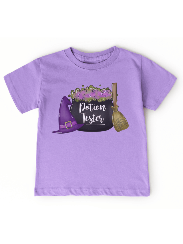 Lavender kids Halloween shirt with Potion Tester design, witch hat, cauldron, and broom
