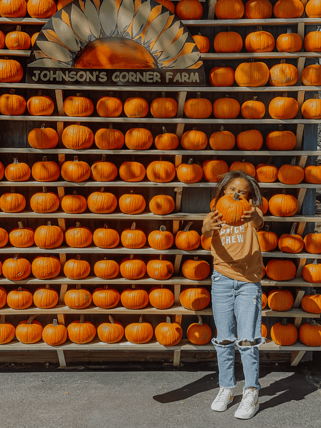 Child wearing Pumpkin Patch Crew shirt at the pumpkin patch – fall outfit idea for toddlers and kids