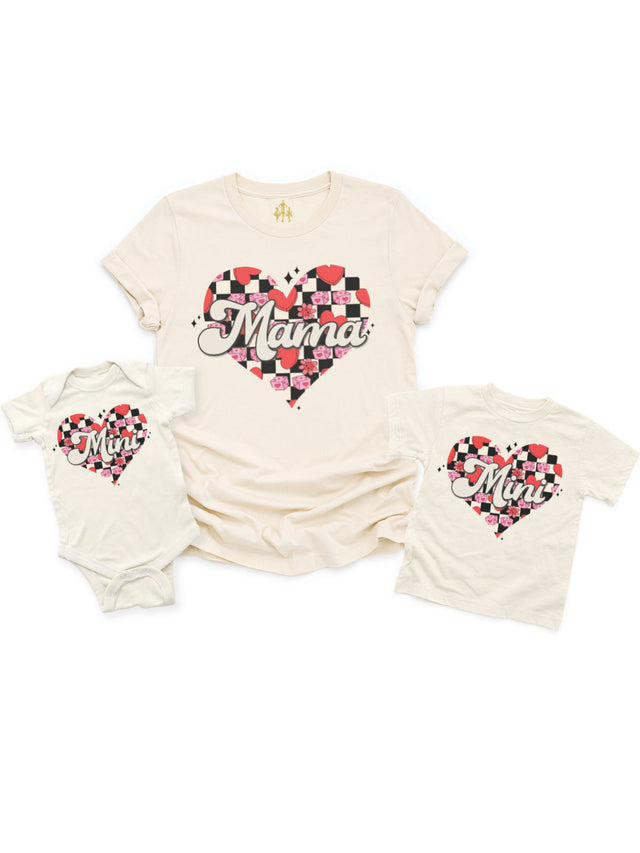 Retro Checkered Mama and Mini matching shirts featuring a heart design with red hearts, pink dice, and flowers, displayed flat as an infant bodysuit, kids' t-shirt, and adult t-shirt in natural cotton.