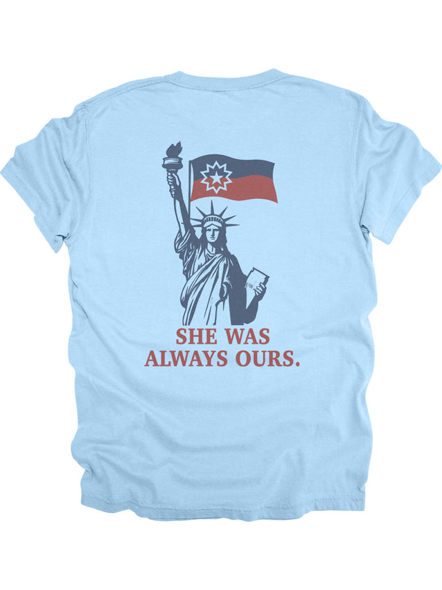 She Was Always Ours Juneteenth design with Lady Liberty and Juneteenth flag on light blue shirt