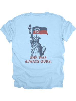 She Was Always Ours Juneteenth design with Lady Liberty and Juneteenth flag on light blue shirt