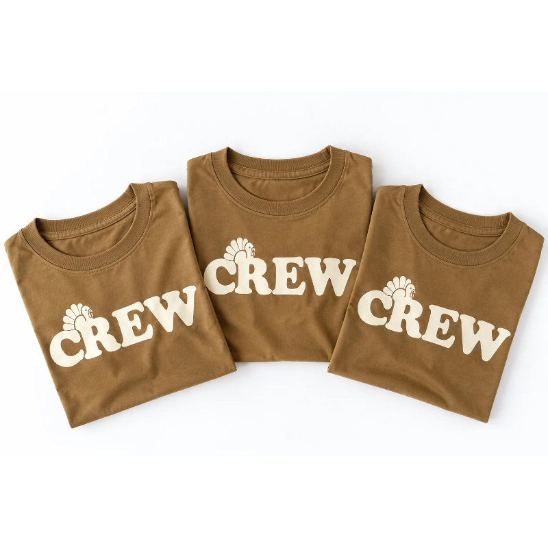 Three brown kids shirts that read CREW in cream with turkey above the R