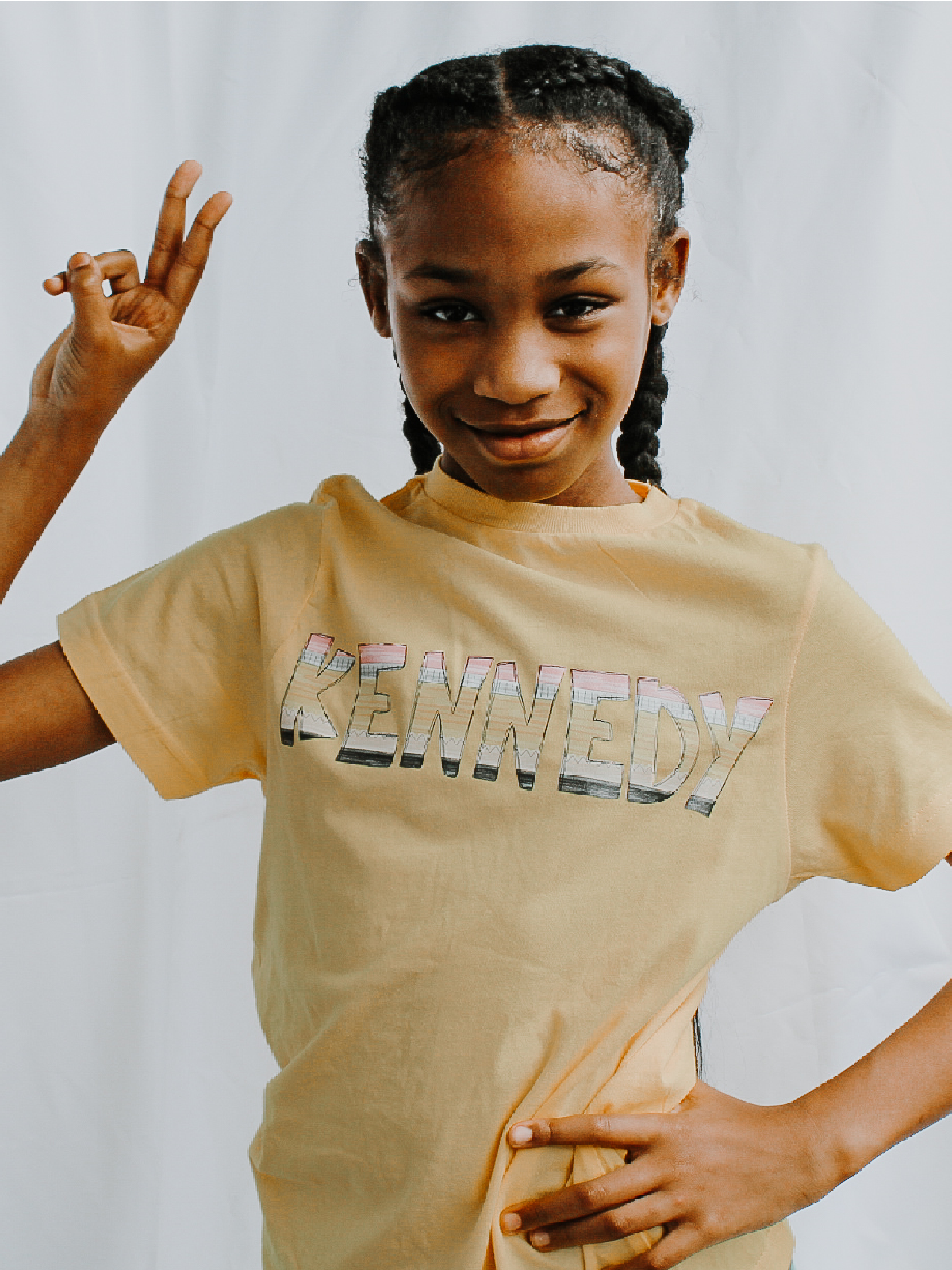 White custom kids t-shirt with colorful pencil font spelling “Kennedy” – personalized back to school shirt for girls