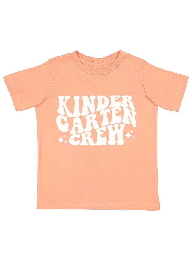 Peach kids t-shirt with “Kindergarten Crew” white retro text and sparkle accents – back to school shirt for girls or boys