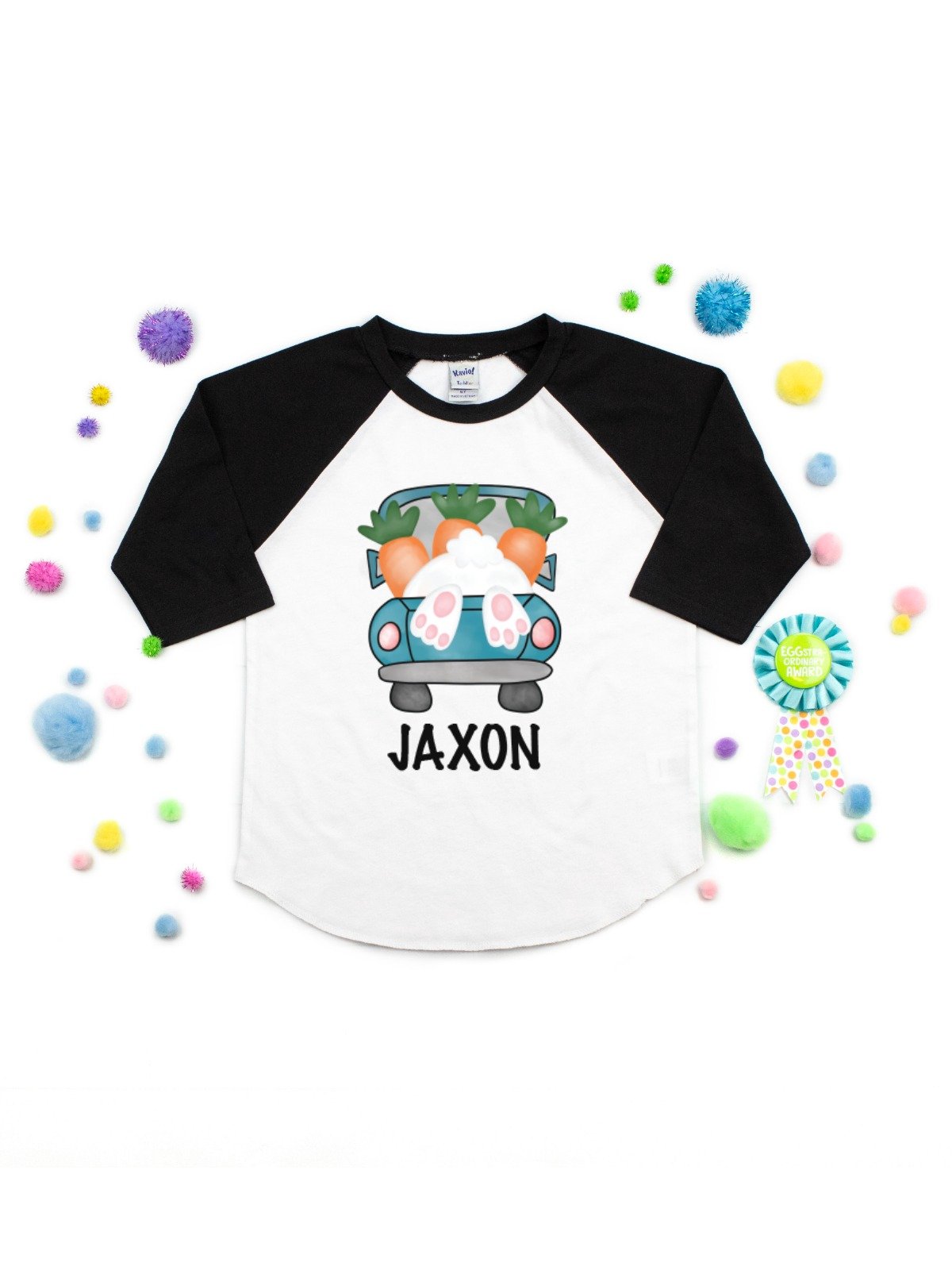 Boys personalized Easter raglan shirt with a bunny and carrot-filled truck design and the name “Evan” on the front.