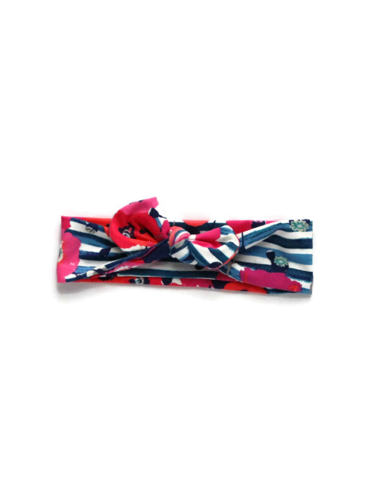 Top knot headband with navy blue and white stripes and bright pink floral print, tied in a bow