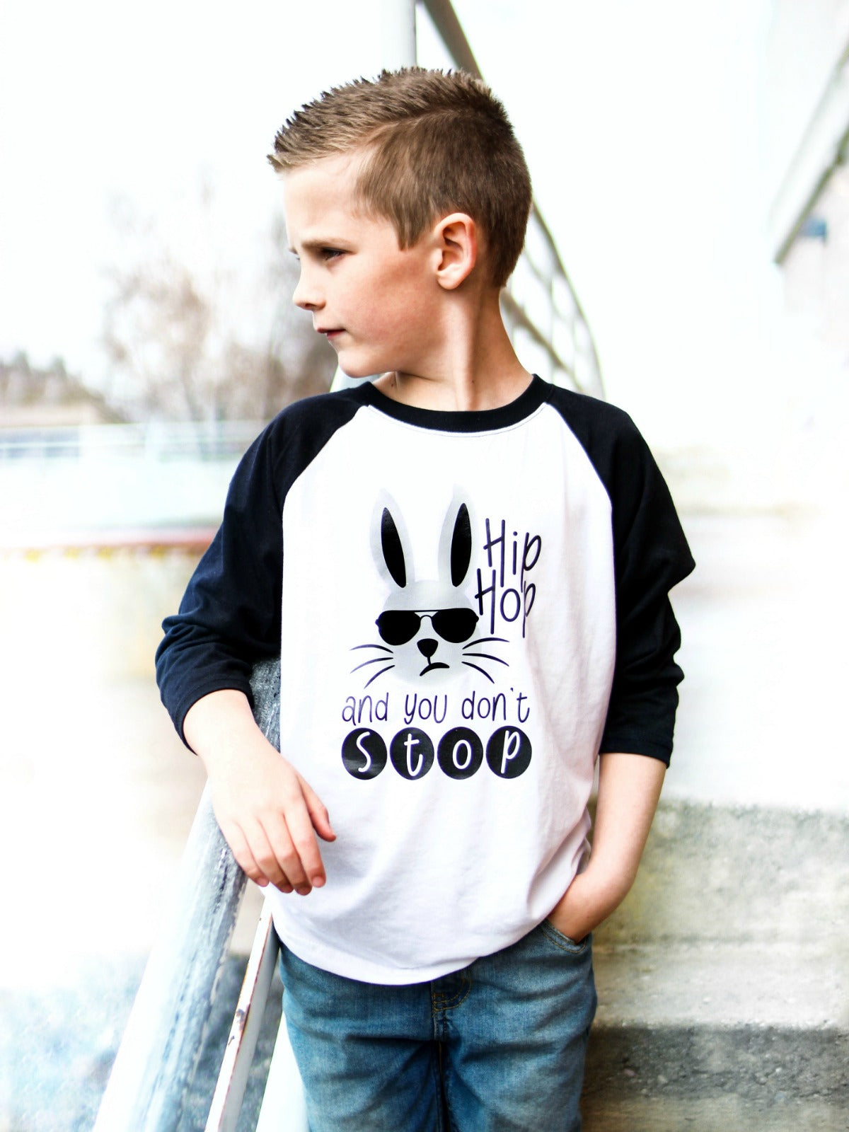 Black and white boys Easter raglan shirt featuring a bunny in sunglasses and the phrase "Hip Hop and You Don’t Stop."