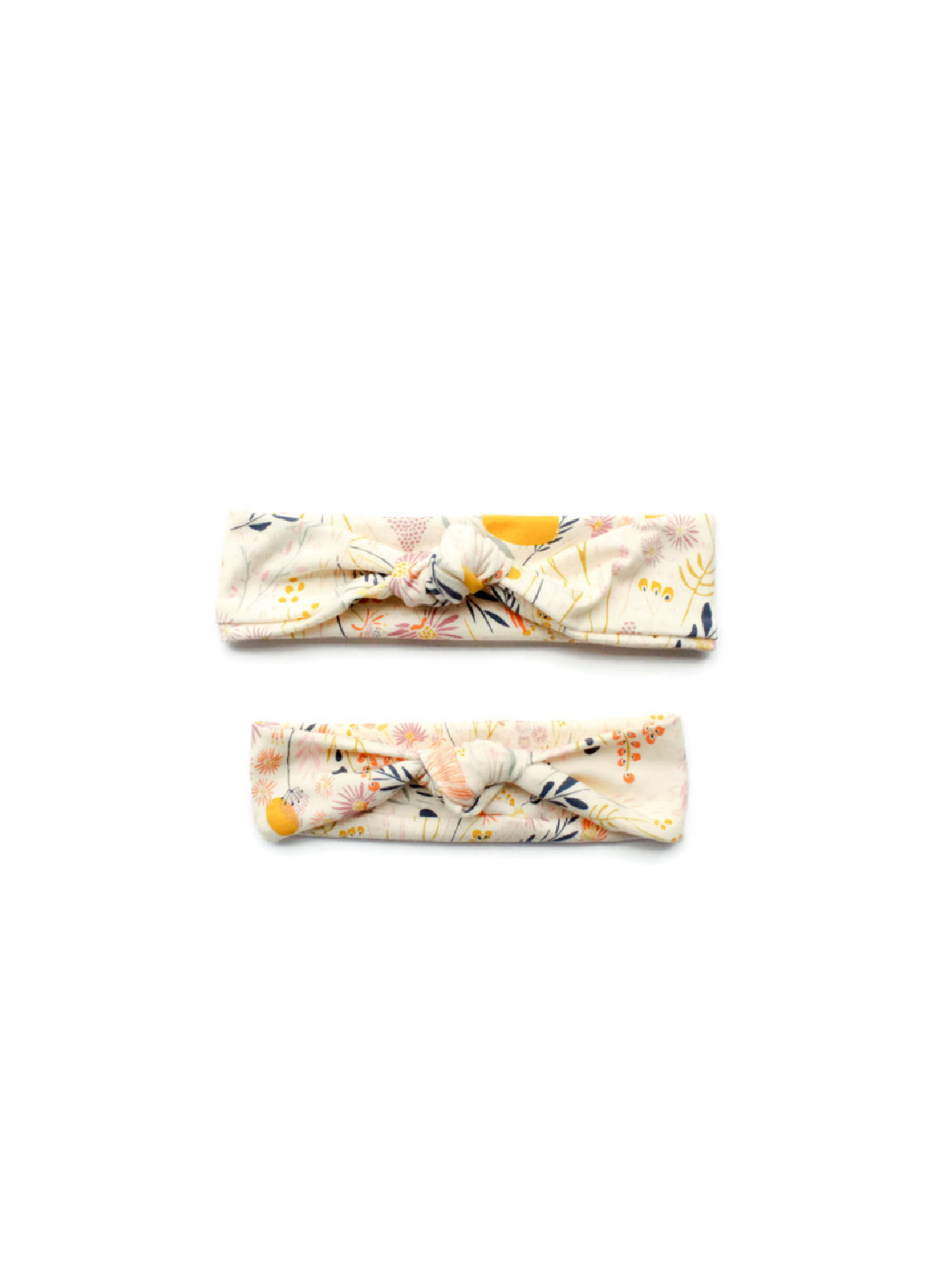 Matching mommy and me knotted headbands with whimsical floral print in pastel and mustard tones